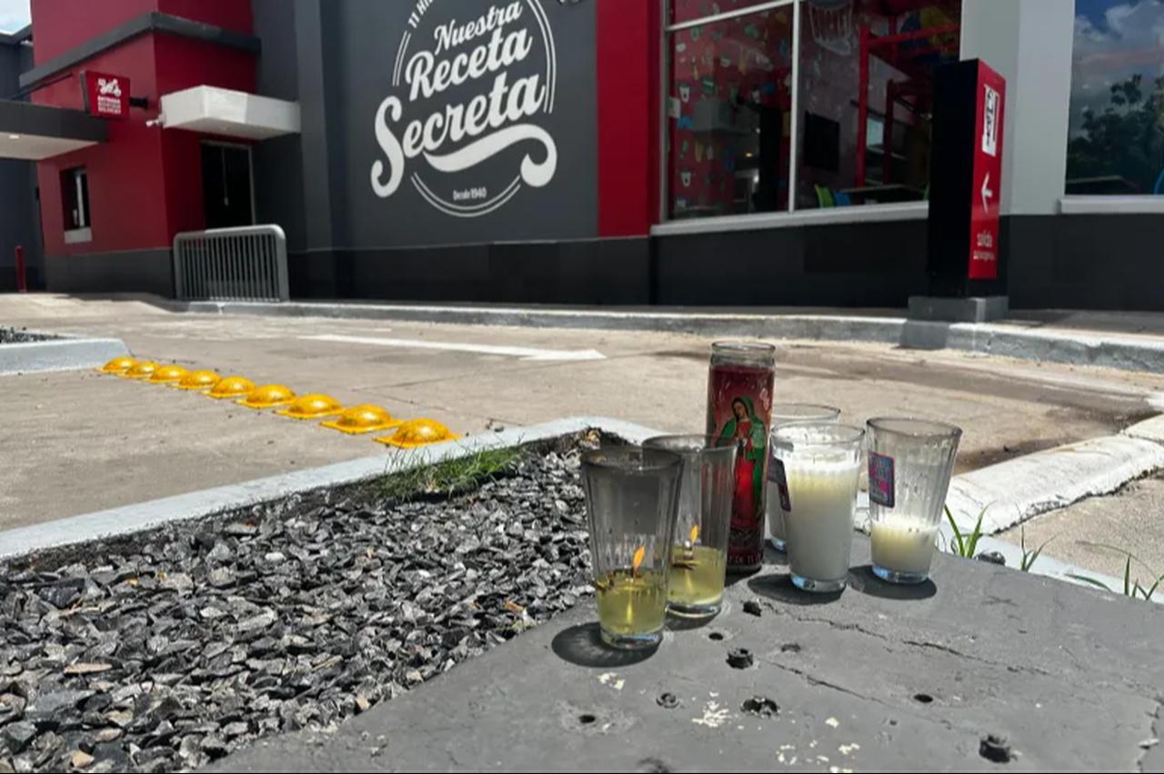 Candles sit near the spot where Cesar Gastelum was killed in Culiacan, Mexico. (AP photo)