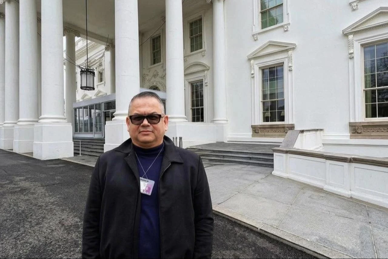 Melih Gogebakan poses outside the White House wearing a visitor badge, in a photograph he shared on social media. (Photo via Facebook)