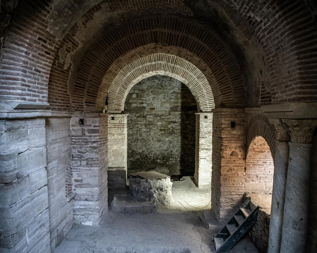 Brick arches and stone columns inside a preserved structure at the Kadikalesi archaeological site in Kusadasi, Türkiye. (IHA Photo)