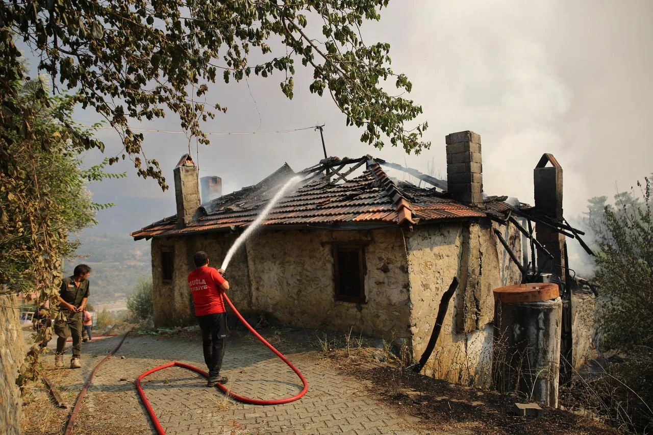 Firefighters battle the wildfire with ground and aerial operations in Seydikemer district of Mugla, Türkiye on July 29, 2026. (AA Photo)