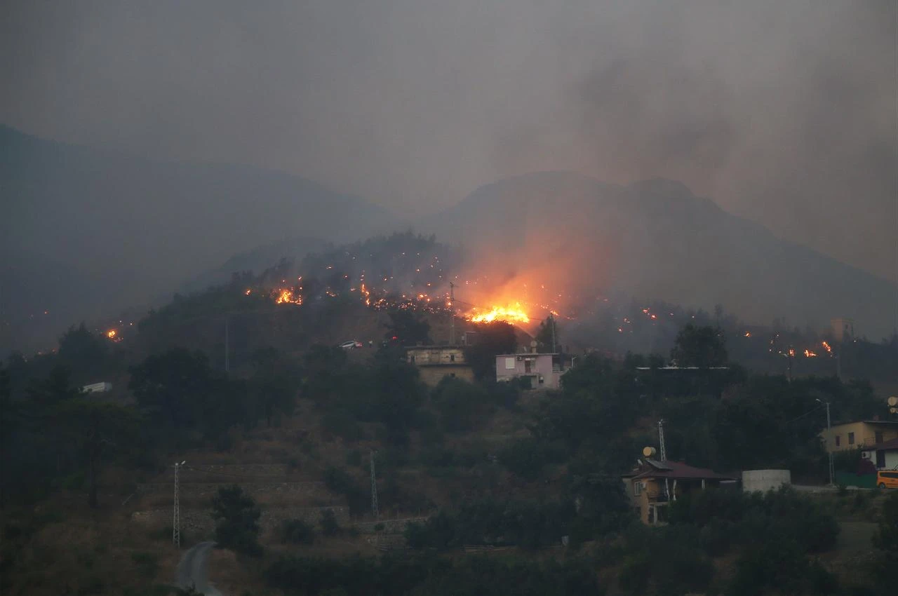 Aerial and ground crews battle a forest fire in the Alanya district of Antalya, Türkiye, on July 29, 2026. (AA Photo)