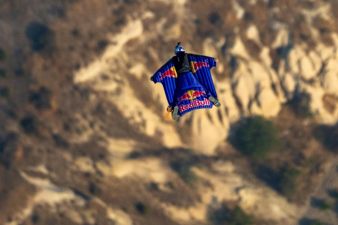 Austrian wingsuit athlete Marco Waltenspiel flies over Cappadocia's dramatic landscape during a high-speed flight in central Türkiye. (AA Photo)
