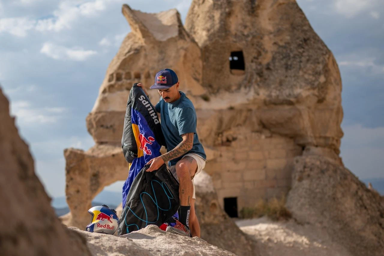 Austrian wingsuit athlete Marco Waltenspiel prepares his gear amid Cappadocia's distinctive rock formations in central Türkiye. (AA Photo)