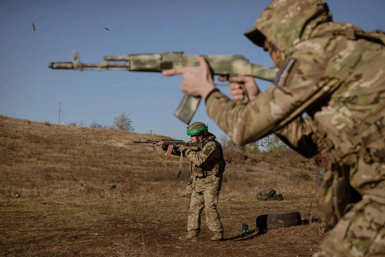 Ukrainian soldier Dzhin from the Ukrainian drone unit of the 24th brigade battalion is shooting with a painted AK-47 during the military training in Donetsk Oblast, Ukraine, October 26, 2024. (AA Photo)