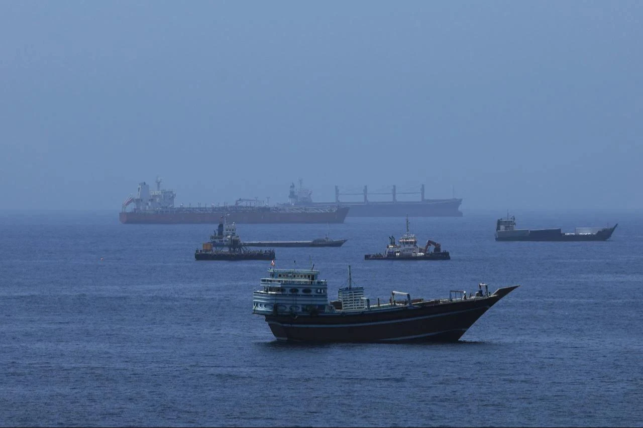 A view of commercial cargo vessels and crude oil tankers are anchored in the Gulf of Oman, off the coast of Muscat, Oman, on June 21, 2026, as they prepare to transit through the critical Strait of Hormuz. (AA Photo)