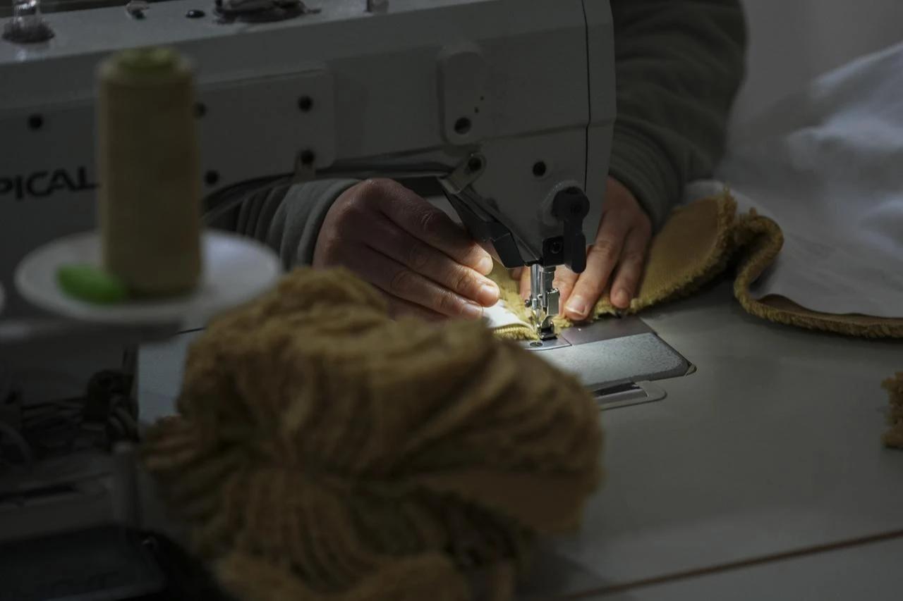 A woman is seen working at a sewing machine in a workshop in Izmir, Türkiye, on January 28, 2026. (AA Photo)