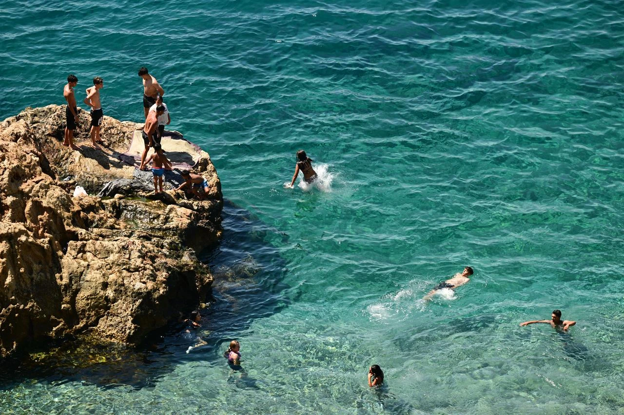 People swim and cool off in the Mediterranean Sea amid hot summer weather in Antalya, Türkiye. (AA Photo)