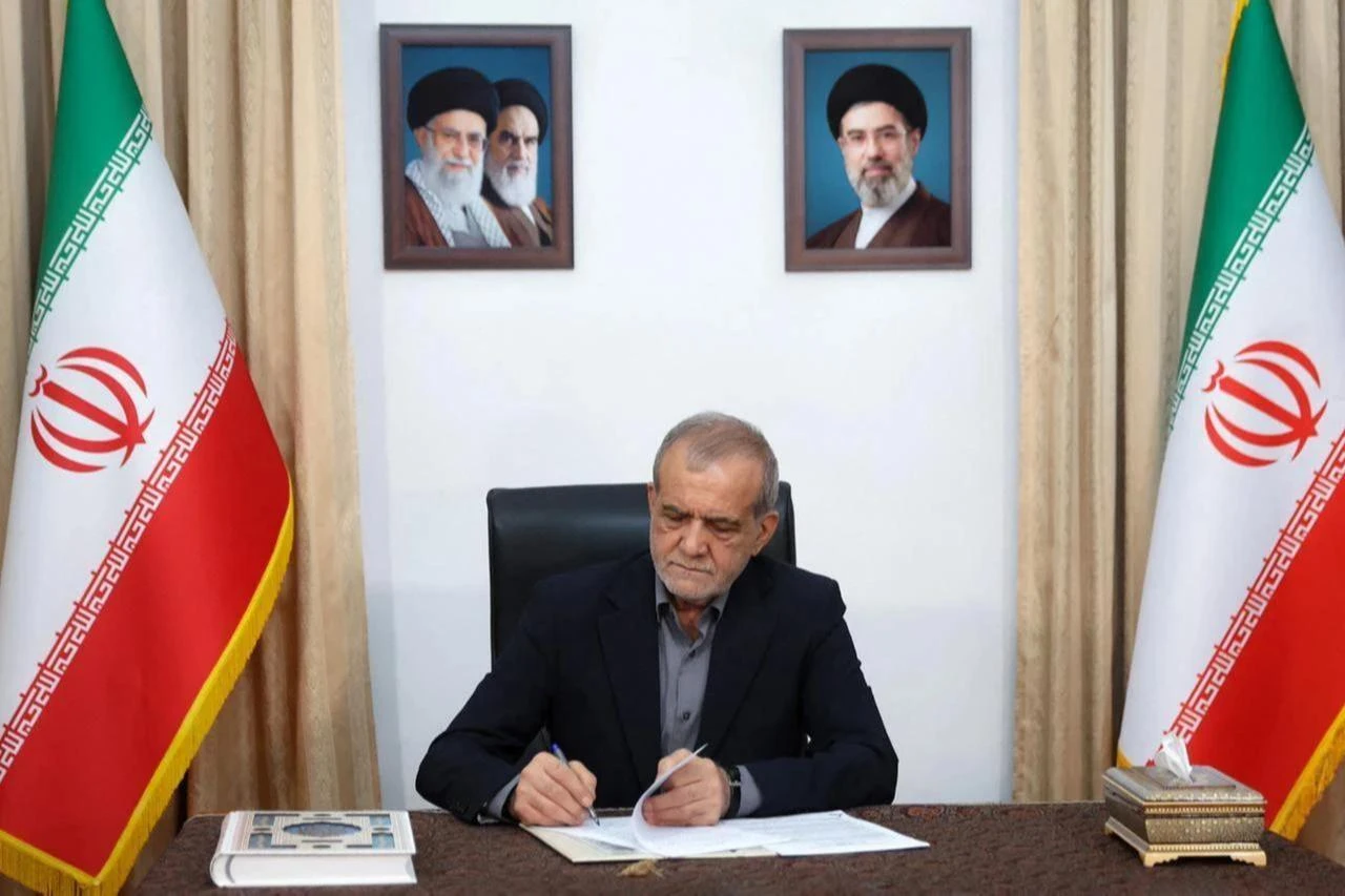 This handout picture released by the Iranian Presidency shows Iran's President Masoud Pezeshkian signing a memorandum of understanding in Tehran, June 18, 2026. (Photo via Iranian Presidency/HO/AFP)