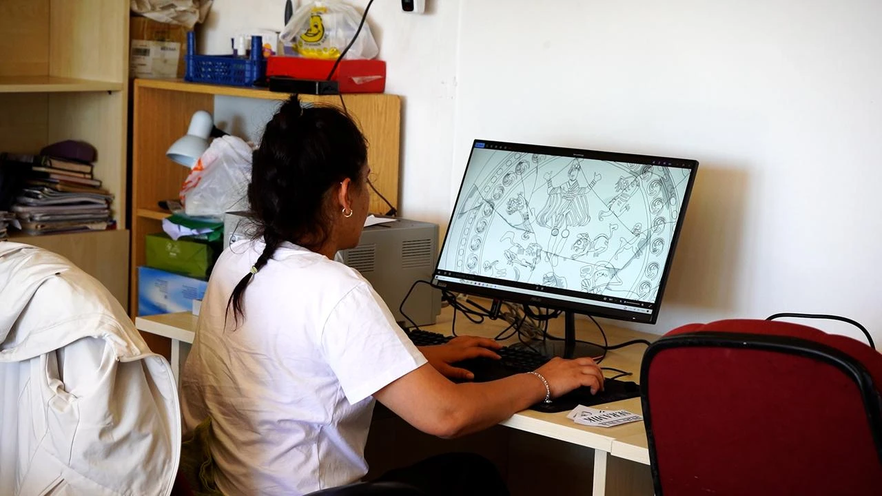 An archaeologist examines a digital reconstruction of the iconographic composition on a 1,500-year-old liturgical vessel uncovered at Antioch of Pisidia in Isparta, Türkiye. (AA Photo)