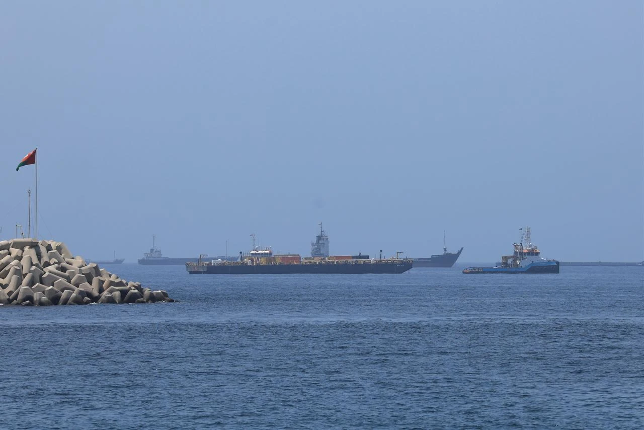 A view of commercial cargo vessels and crude oil tankers are anchored in the Gulf of Oman, off the coast of Muscat, Oman, on June 21, 2026, as they prepare to transit through the Strait of Hormuz. (AA Photo)