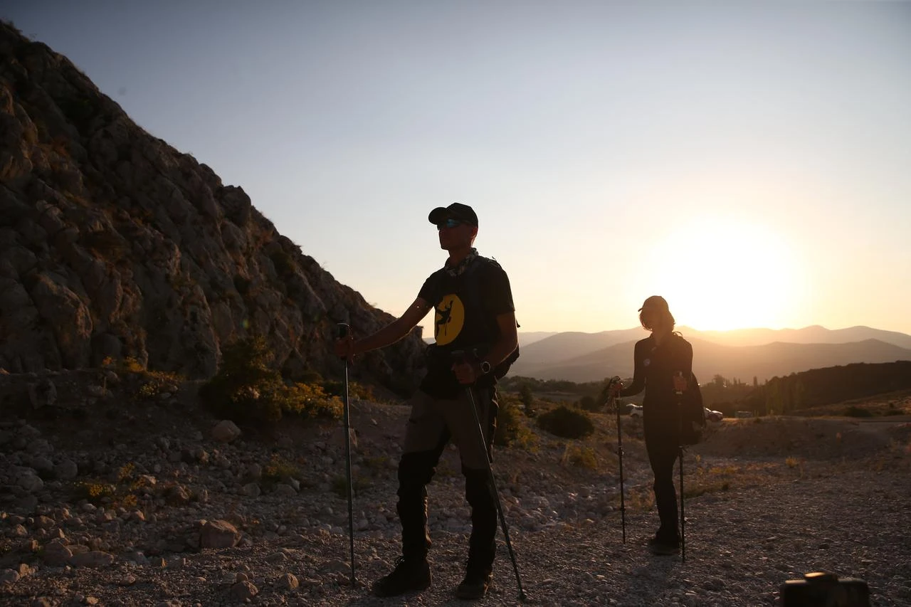 Hikers trek through the rocky terrain of the Aladağlar mountain range at sunset in Nigde, Türkiye, Aug. 9, 2026. (AA Photo)