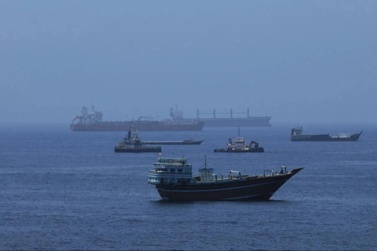 A view of commercial cargo vessels and crude oil tankers are anchored in the Gulf of Oman, off the coast of Muscat, Oman, on June 21, 2026, as they prepare to transit through the critical Strait of Hormuz. (AA Photo)