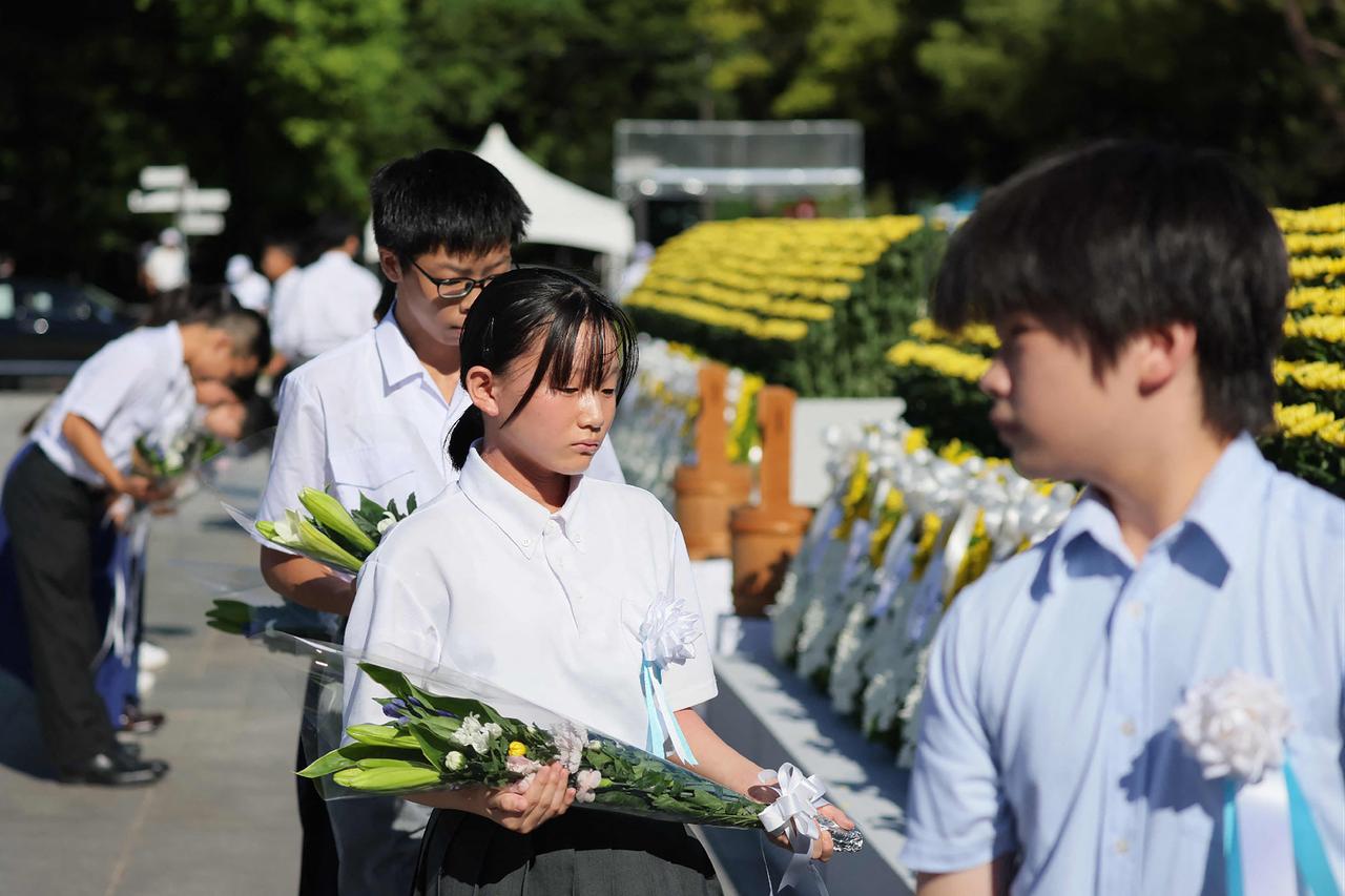 Representatives of Hiroshima's children offer flowers at the Peace Memorial Ceremony, on the 81st anniversary of the dropping of the atomic bomb, at the Peace Memorial Park in Hiroshima, August 6, 2026. (AFP Photo)