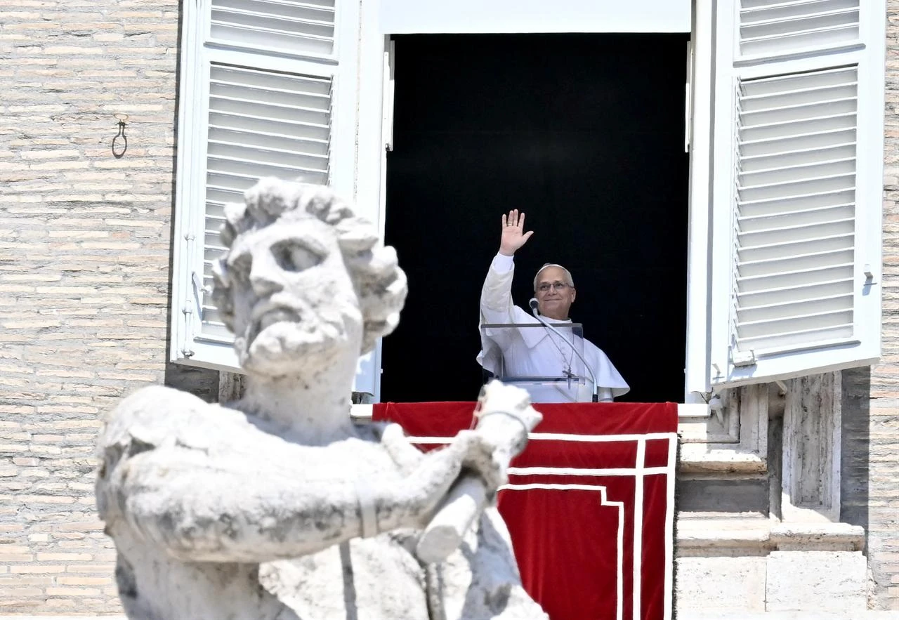 Pope Leo XIV waves during his Angelus prayer from a balcony overlooking St. Peter's Square at the Vatican, August 9, 2026. (AFP Photo)