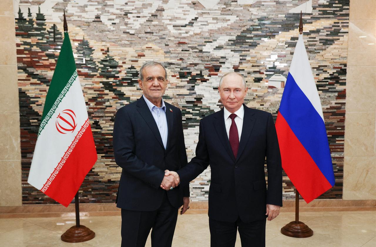 In this pool photograph distributed by the Russian state agency Sputnik, Russia's President Vladimir Putin and Iran's President Masoud Pezeshkian shake hands during a meeting on the sidelines of the Shanghai Cooperation Organisation (SCO) summit in Bishkek on September 1, 2026. (Photo by Sputnik / AFP)