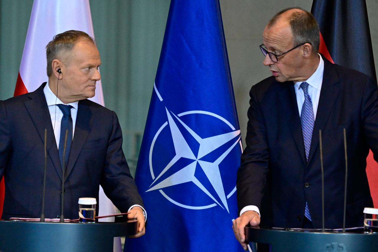 German Chancellor Friedrich Merz (R) and Poland's Prime Minister Donald Tusk address a press conference following talks on December 1, 2025 at the Chancellery in Berlin, Germany. (AFP Photo)