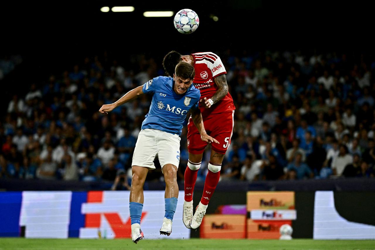 Napoli's Italian midfielder #02  Costantino Favasuli and Arsenal's Ecuadorian defender #05 Piero Hincapie jump to head the ball during the UEFA Champions League - League Phase, Matchday 1 - football match between Napoli and Arsenal at the Stadio Diego Armando Maradona in Naples on September 9, 2026. (AFP Photo)
