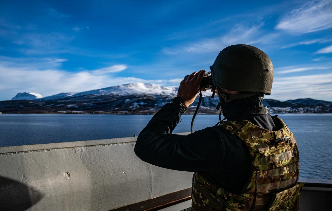 A sailor looks through his binoculars on the San Giusto, a San Giorgio-class amphibious transport dock of the Italian Navy, off the coast of Harstad on March 11, 2026, as NATO conducts its Cold Response military exercise. (AFP Photo)