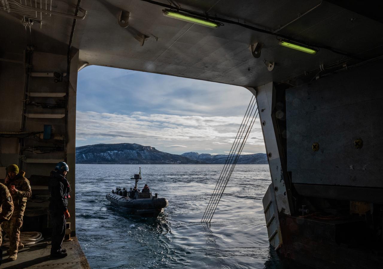 Sailors operate an outboard boat near the San Giusto, a San Giorgio-class amphibious transport dock of the Italian Navy, off the coast of Harstad on March 11, 2026, as NATO conducts its Cold Response military exercise. (AFP Photo)