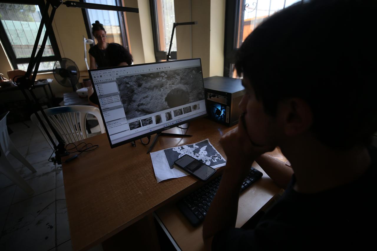 Members of the Andik Cave excavation team document archaeological finds as part of ongoing research in Havran, Balikesir, Türkiye. (AA Photo)