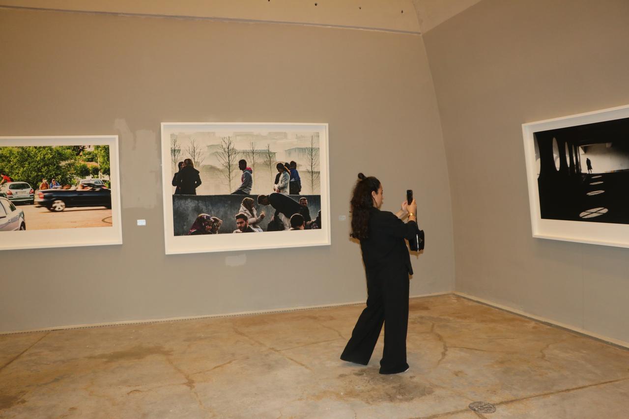 A visitor photographs works from Zeki Demirkubuz's exhibition at Baksi Museum in Bayburt, Türkiye. (AA Photo)