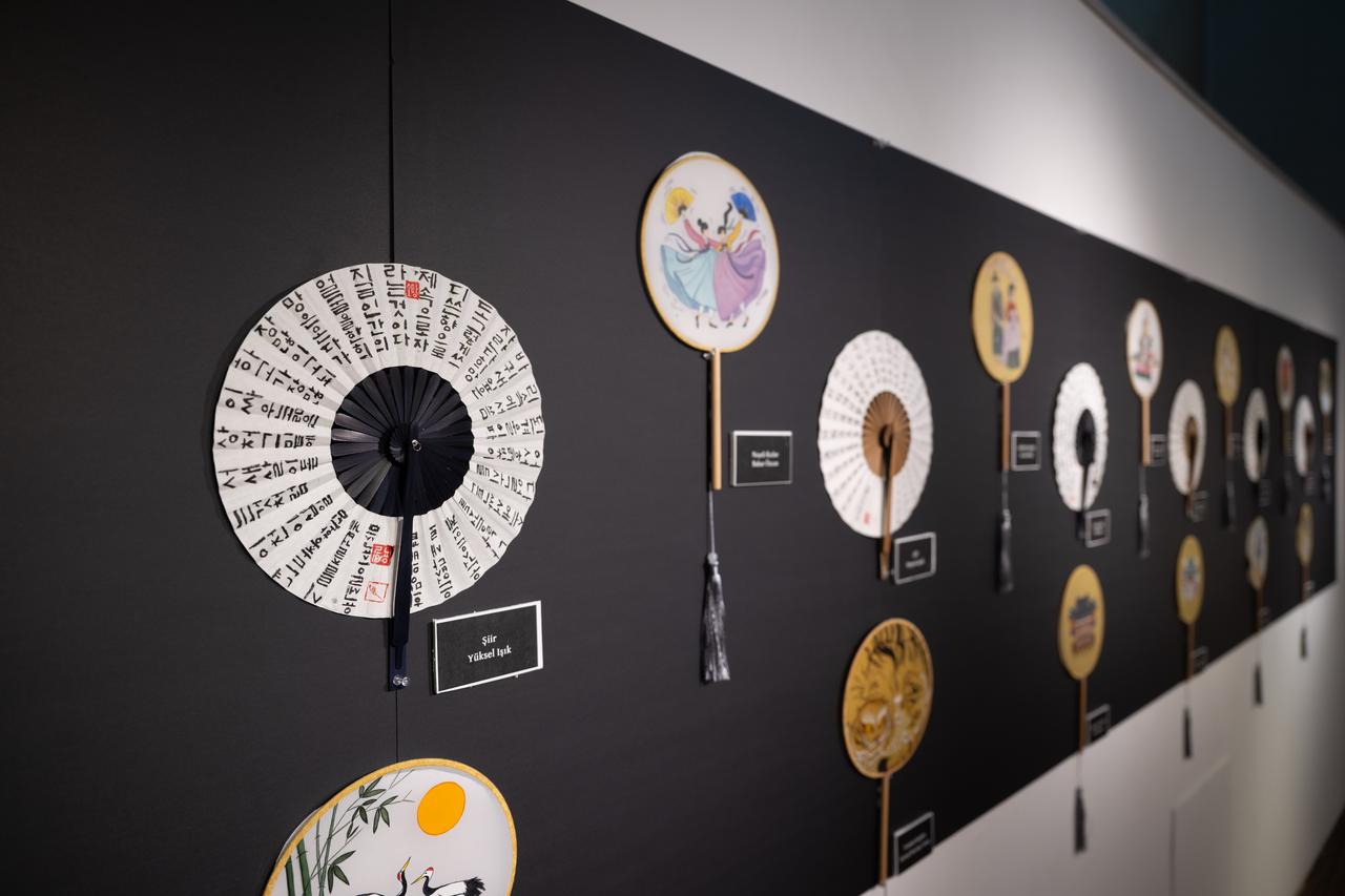 Traditional Korean fans featuring calligraphy and painted motifs are displayed at the Korean Cultural Center in Ankara, Türkiye. (AA Photo)