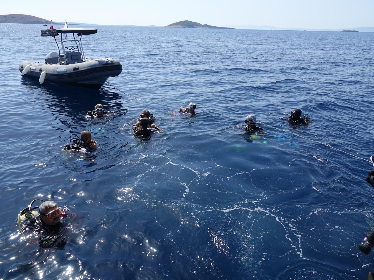 Scuba divers gather in the water before exploring underwater sites off Ayvalik, Balikesir, Türkiye, Sept. 13, 2026. (AA Photo)
