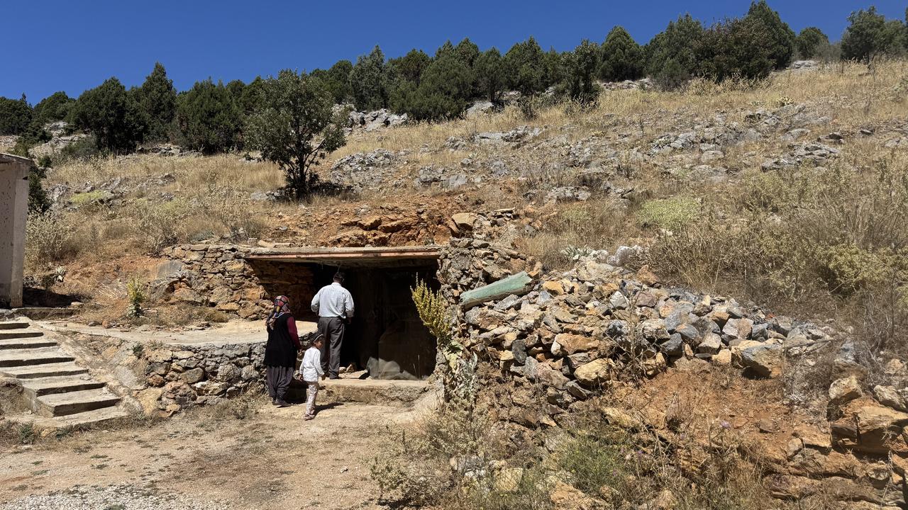 Local residents approach the entrance of the cave used to store dairy products in Gokceyurt Neighborhood in Konya's Ilgin district, Türkiye. (AA Photo)