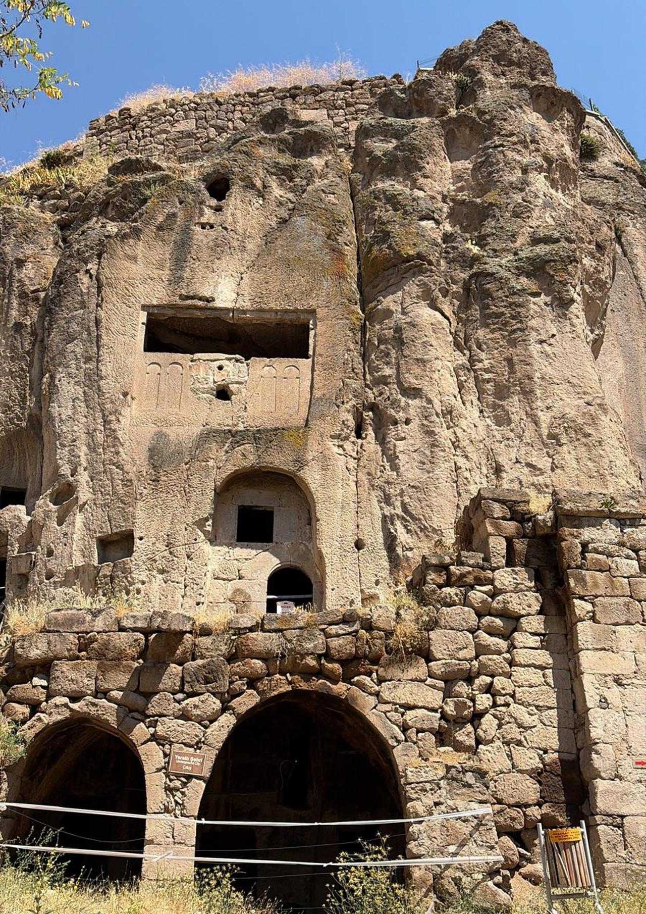 Frontal view of the rock-carved structures and underground city entrance in Guzelyurt, Aksaray.(Photo via Türkiye Today Staff)