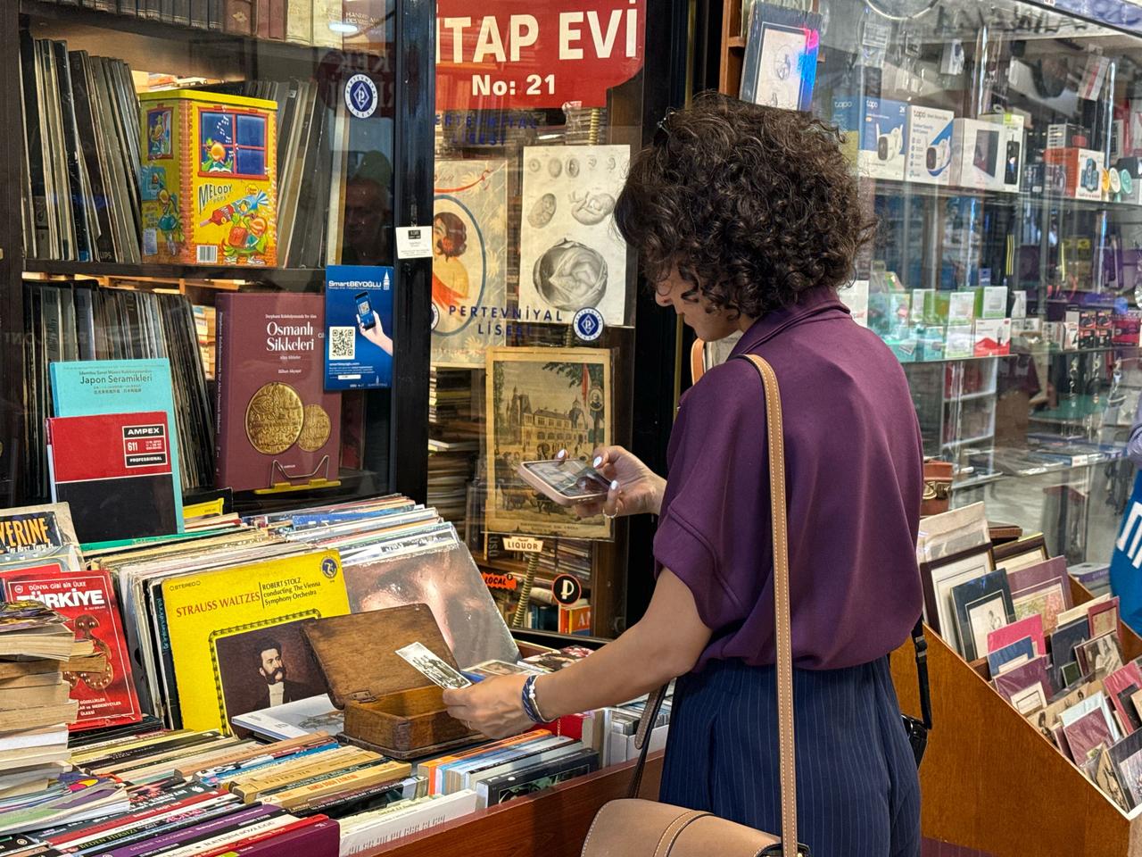 A participant examines books and archival items during a heritage discovery route organized as part of European Heritage Days 2026 in Istanbul's Beyoglu district, Türkiye. (AA Photo)