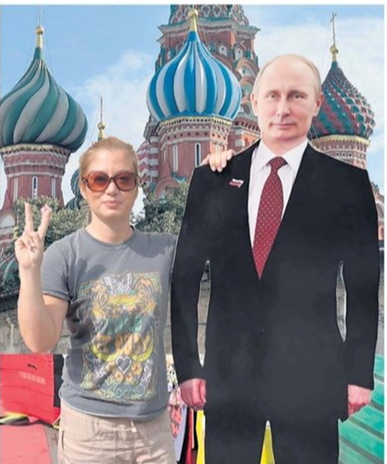 Janina White poses with a cardboard cut-out of Vladimir Putin. (Photo via The Telegraph)