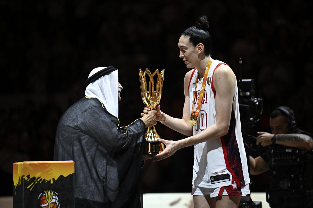 USA's power forward #10 Breanna Stewart (R) receives the trophy after the 2026 FIBA Women’s Basketball World Cup final game between the United States and France in Berlin on September 13, 2026. (AFP Photo)