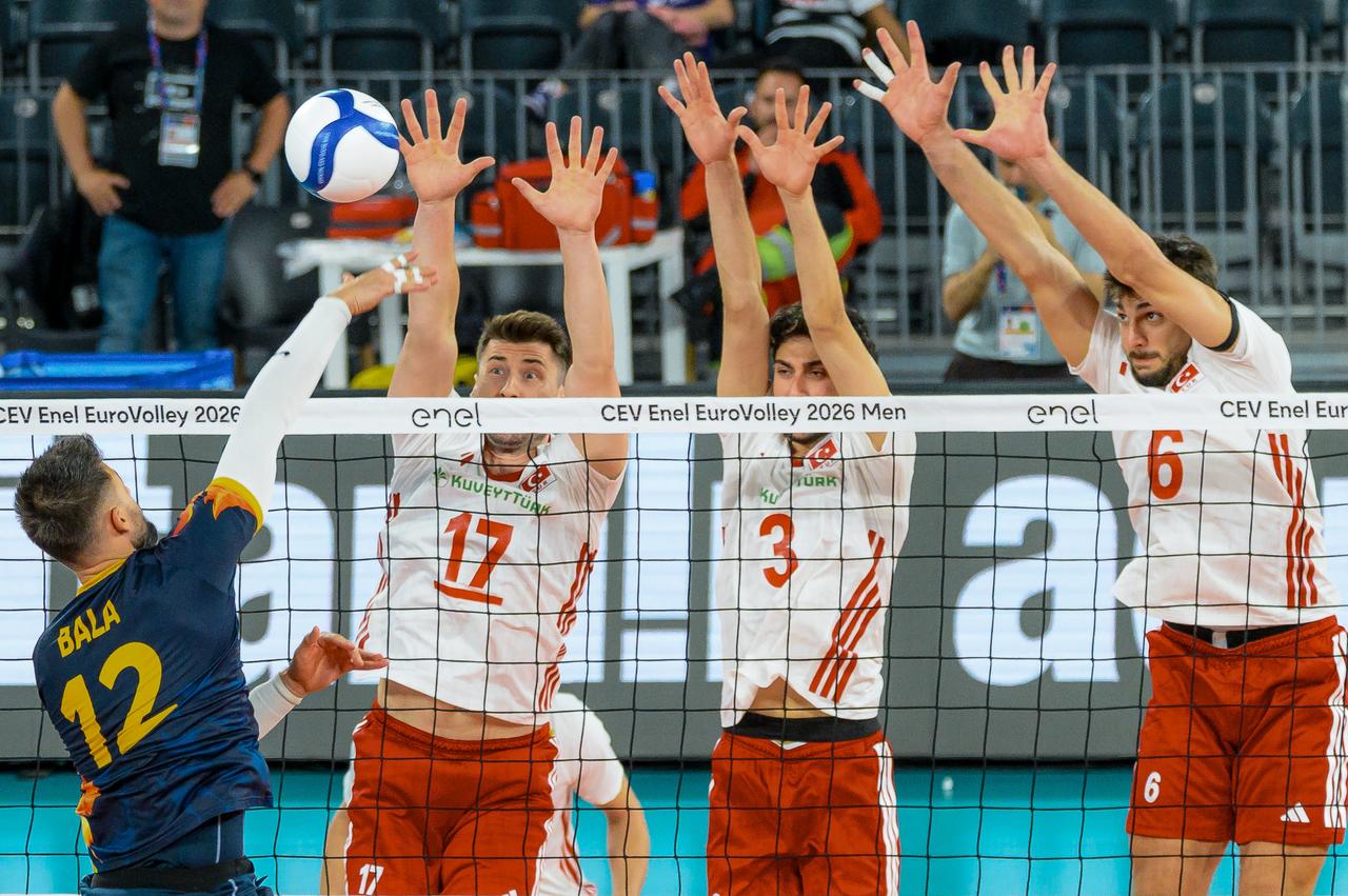 Romania's Marian Iulian Bala attacks against Türkiye's Murat Yenipazar, Ahmet Tumer and Gokcen Yuksel during the CEV Enel EuroVolley 2026 men's Group D match at BT Arena in Cluj-Napoca, Romania, Sept. 14, 2026. (AA Photo)