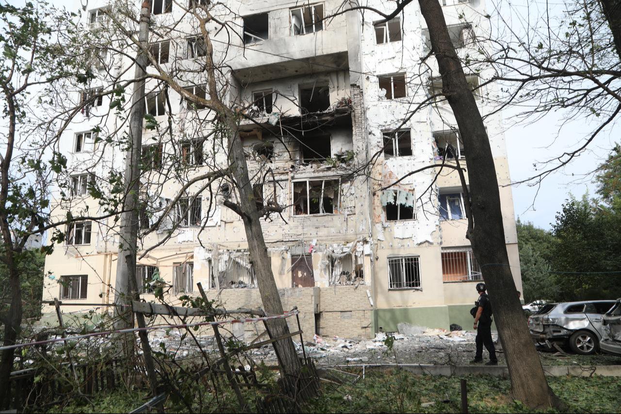 Multi-story residential buildings, warehouses, and utility structures are seen damaged as firefighters and emergency personnel operate at the scene in Ukraine, Sept. 13, 2026. (AA Photo)