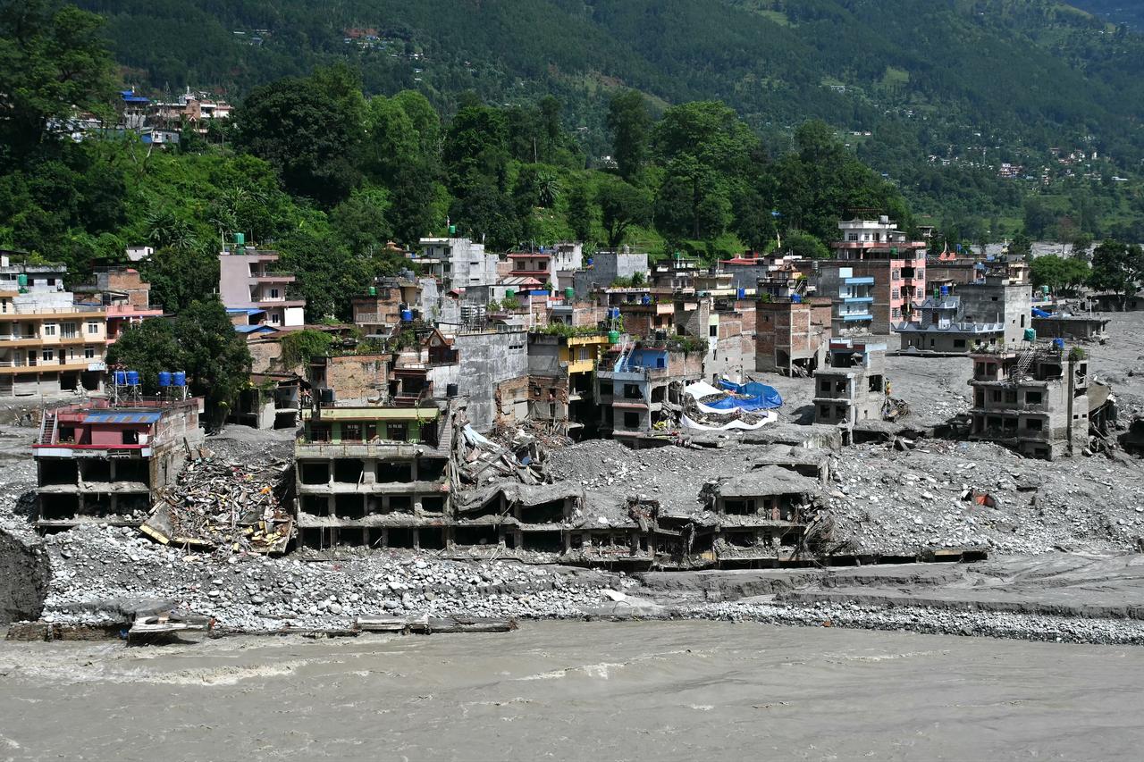 Flood-damaged homes and buildings are buried in mud and debris along the Trishuli River in Trishuli, Nuwakot district, Nepal, Sept. 11, 2026. (AFP Photo)