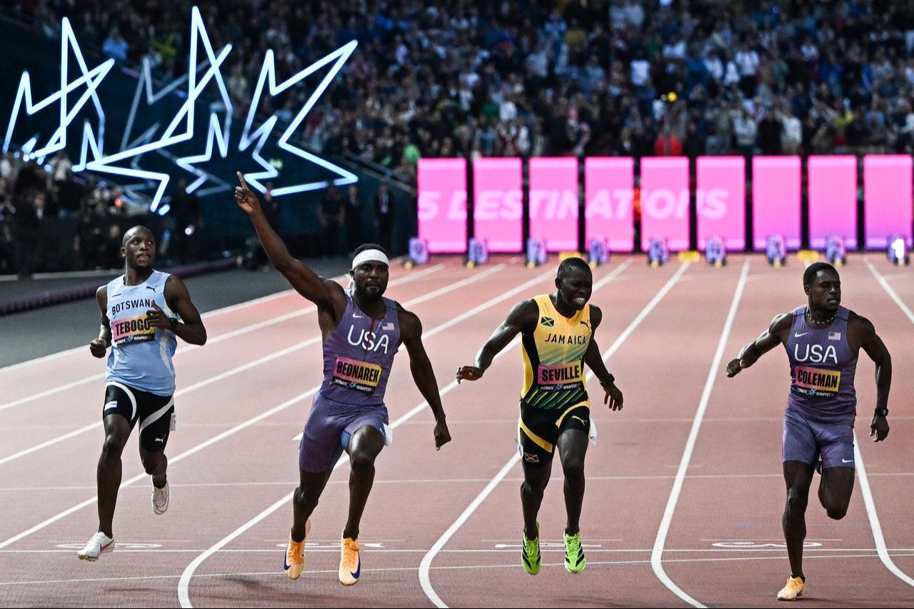 U.S. sprinter Kenny Bednarek celebrates after winning the men's 100-meter final ahead of Jamaica's Oblique Seville, with Botswana's Letsile Tebogo and U.S. sprinter Christian Coleman also pictured, at the World Athletics Ultimate Championship in Budapest, Hungary, Sept. 12, 2026. (AFP Photo)