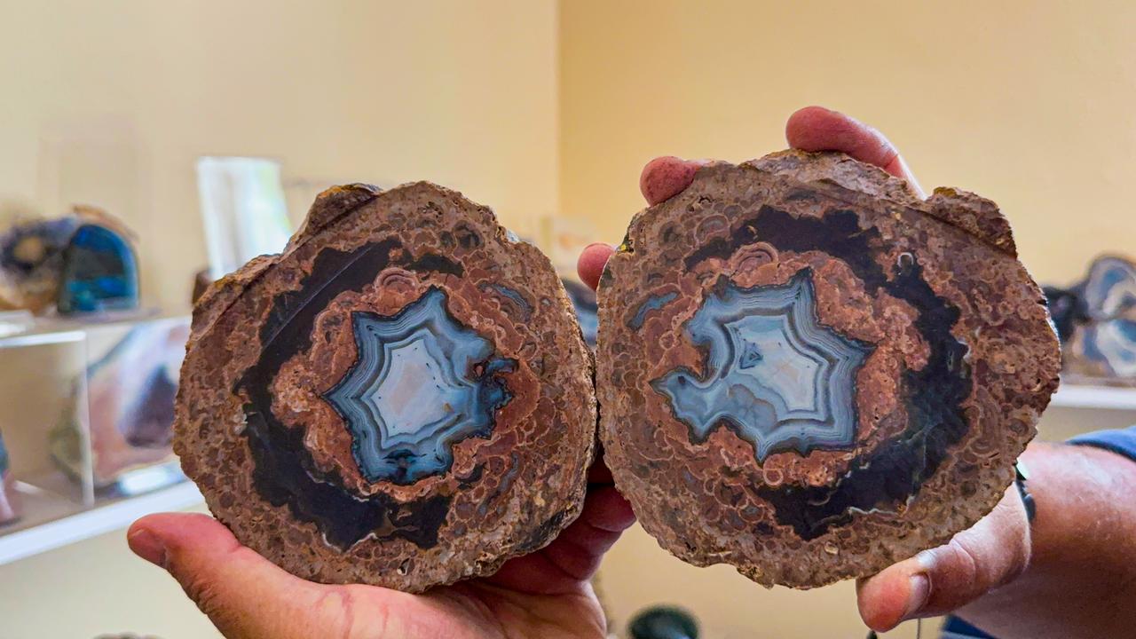 Sculptor Erol Gurses holds a pair of cut and polished mineral stones revealing intricate natural patterns inside his workshop in the Aydincik district of Yozgat, Türkiye, Sept. 16, 2026. (AA Photo)