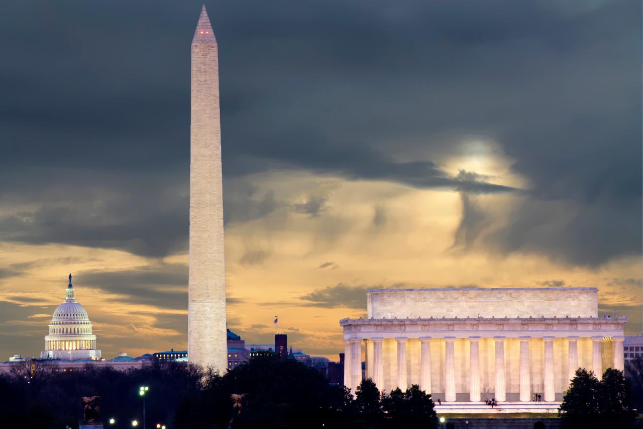 The U.S. Capitol, Washington Monument and Lincoln Memorial are seen under storm clouds in Washington, D.C., in an undated photo. (Photo via Adobe Stock)