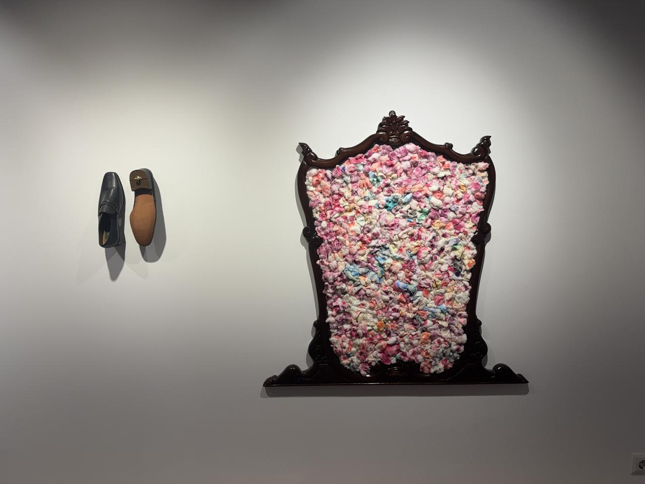 A mixed-media artwork incorporating an ornate frame and a pair of shoes is displayed during Artweeks Istanbul's "Collectors" edition at Akaretler Siraevler in Besiktas, Istanbul, Türkiye, Sept. 16, 2026. (AA Photo)