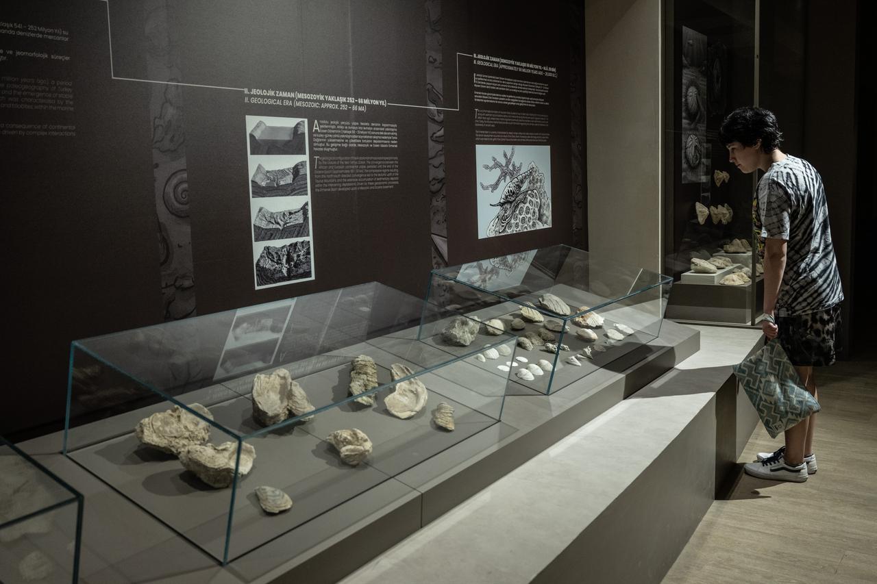 A visitor examines exhibits at the Ahmet Kelesoglu Archaeology and Ethnography Museum in Ermenek, Karaman, Türkiye. (AA Photo)