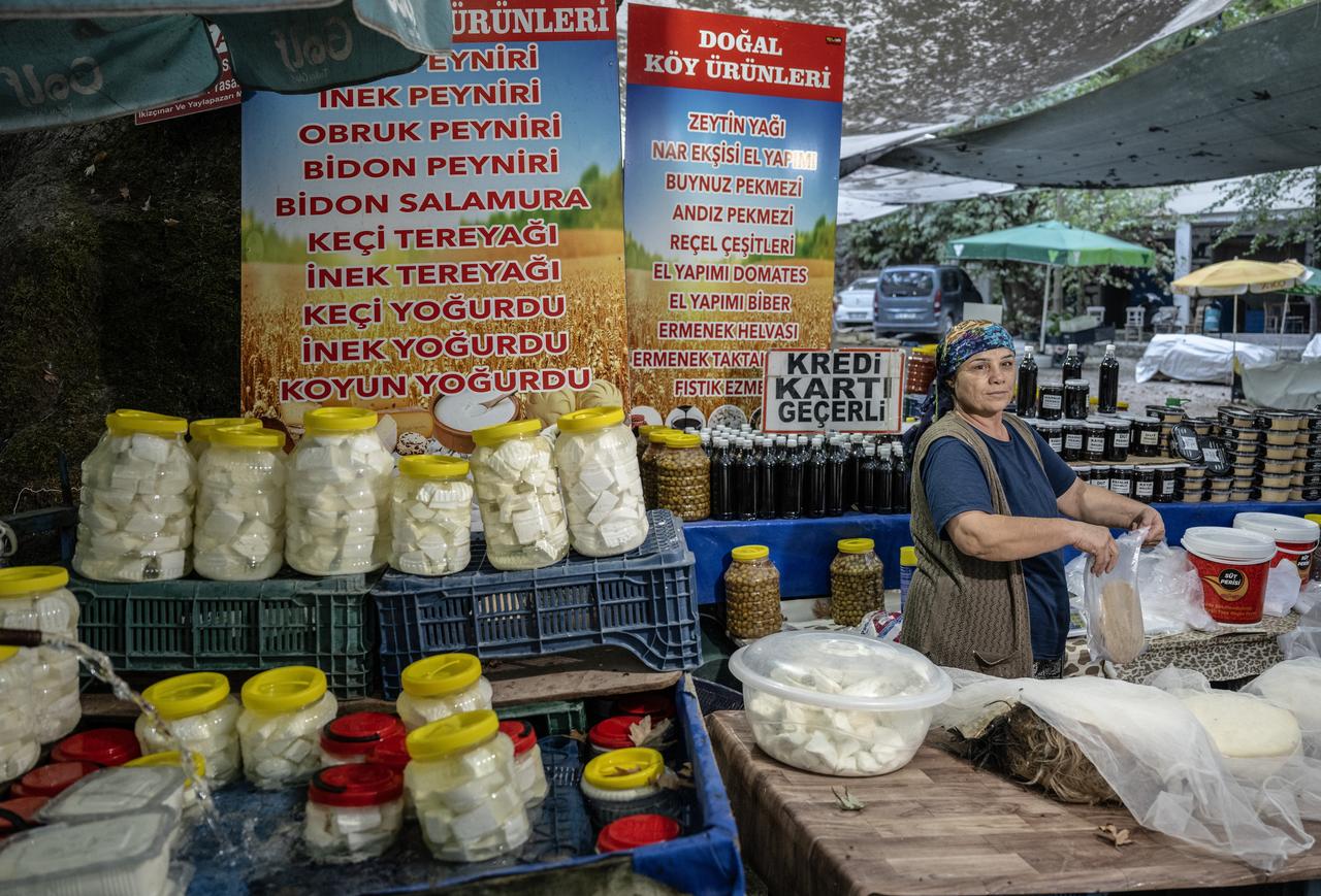 A local vendor sells regional dairy products and other traditional goods at Zeyve Market in Ermenek, Karaman, Türkiye. (AA Photo)