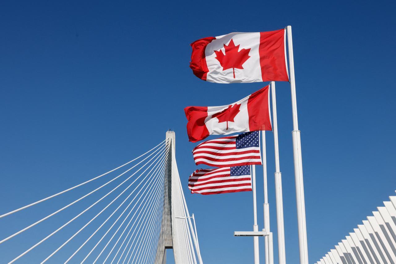 Flags of Canada and United States fly across the international border on the Gordie Howe International bridge that connects Windsor, Ontario, Canada and Detroit, Michigan on September 6, 2026. (AFP Photo)