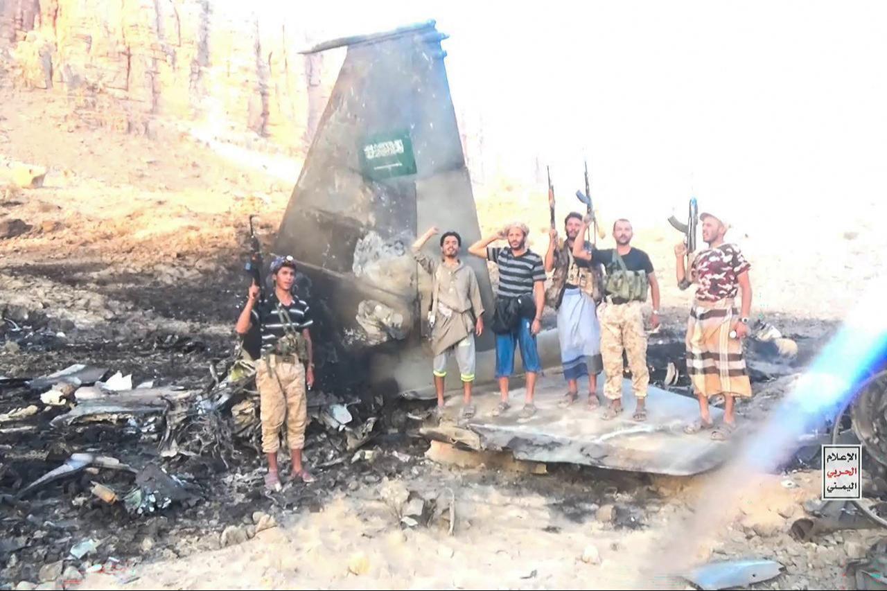 Fighters affiliated with Houthi authorities posing in the midst of what the Houthi military said is the wreckage of a Saudi F-15 fighter jet that was shot down in the central province of Marib, Sept. 16, 2026. (AFP Photo/Handout/Ansarullah Media Centre)