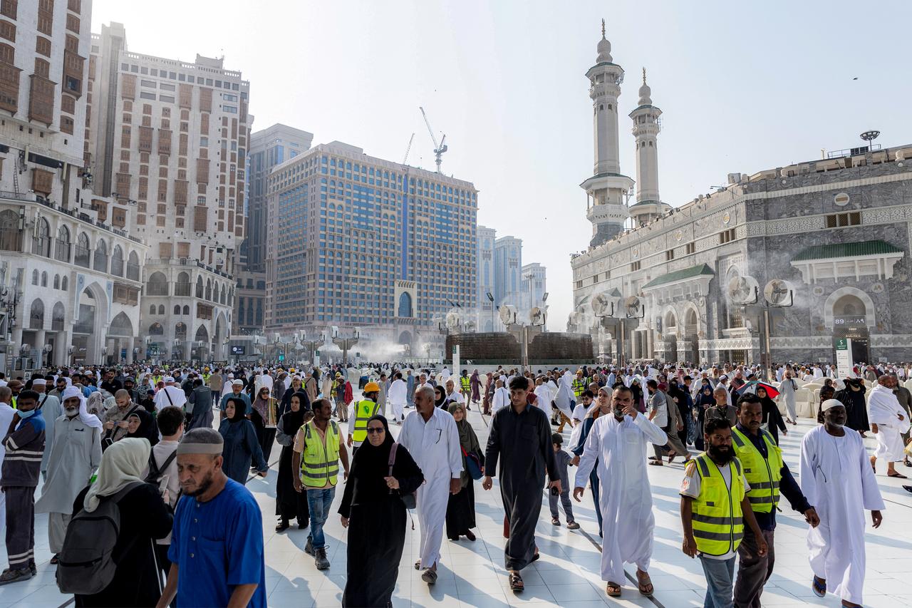 People and pilgrims walk at the Grand Mosque Complex in Saudi Arabia's holy city of Mecca on September 16, 2026. (AFP Photo)