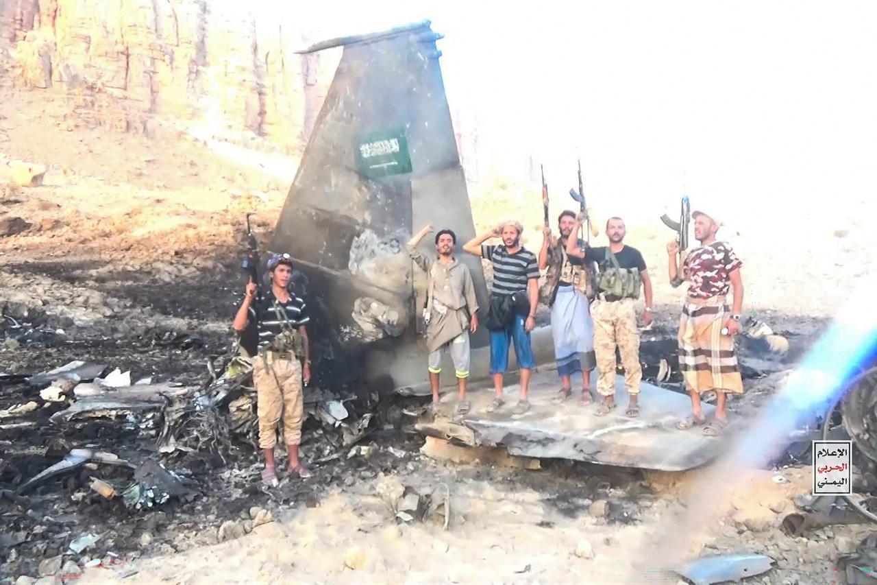 This handout picture released on September 16, 2026 by Ansarullah Media Centre shows fighters affiliated with Houthi authorities posing in the midst of what the Houthi military said is the wreckage of a Saudi F-15 fighter jet that was shot down in the central province of Marib. (AFP Photo)
