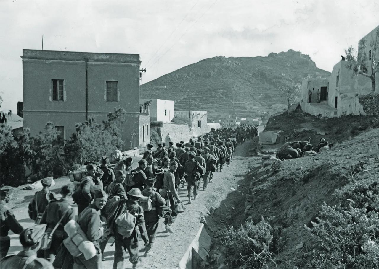 British troops captured after the surrender of Leros on Nov. 16, 1943, march toward POW ships bound for mainland Europe. (Photo via Tony Rogers Collection)