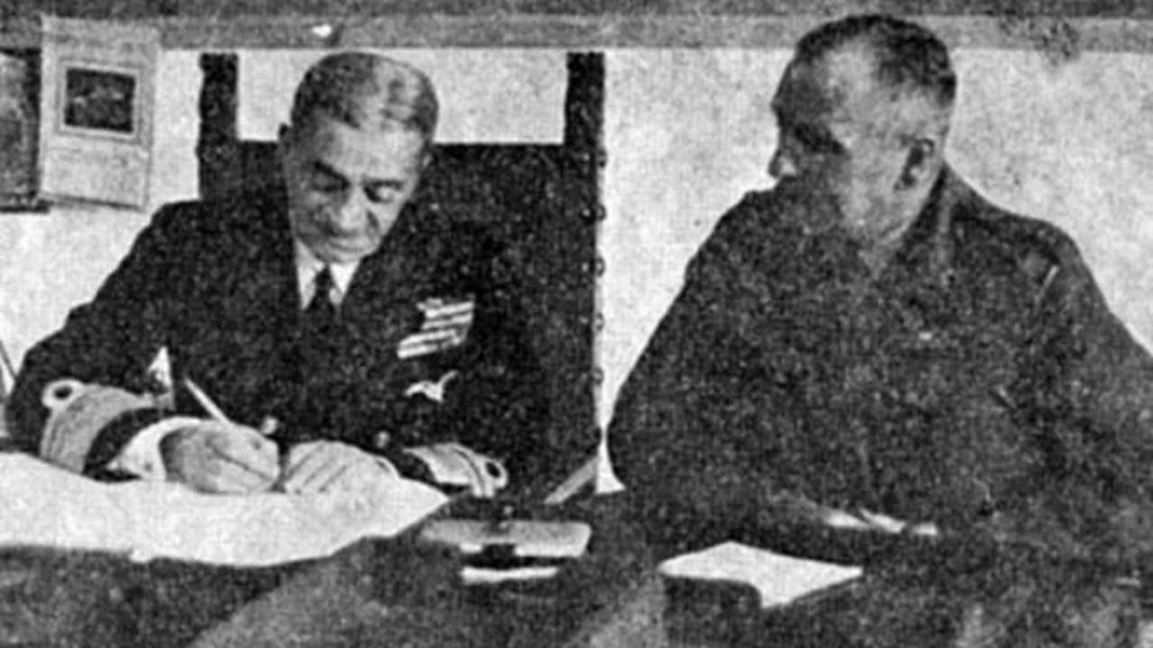 Rear Adm. Pericles Ioannidis signs the protocol for the handover of the Dodecanese to Greece. (Photo via Keep Talking Greek)