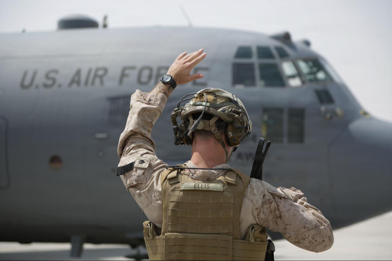 A U.S. Marine uses hand-and-arm signals to direct a C-130H Hercules before takeoff in the U.S. Central Command area of responsibility, Sept. 10, 2026. (Photo via U.S. Marine Corps)