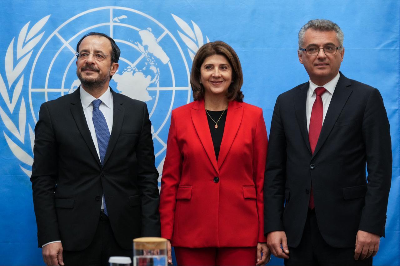 Greek Cypriot leader Nikos Christodoulides (L) and Turkish Cypriot President Tufan Erhurman (R) meet with the Personal Envoy of the United Nations Secretary-General on Cyprus, Maria Angela Holguin, in the UN buffer zone, Dec. 11, 2025. (AFP Photo)