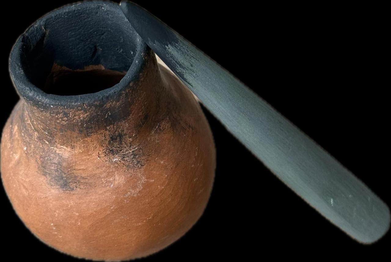An approximately 8,000-year-old cosmetic applicator and container unearthed at Yesilova Hoyugu, offering evidence of personal adornment among Izmir's early residents. (IHA Photo)